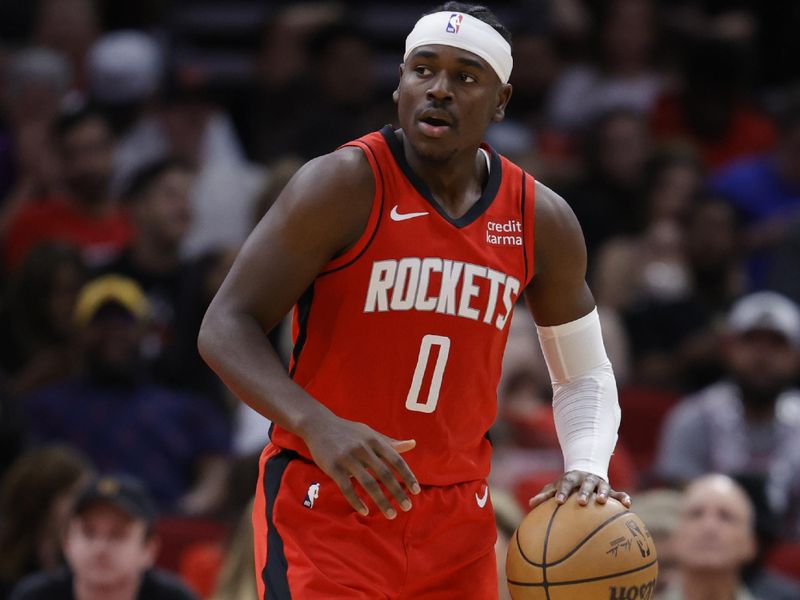 HOUSTON, TEXAS - NOVEMBER 06: Aaron Holiday #0 of the Houston Rockets controls the ball \ during the second half at Toyota Center on November 06, 2023 in Houston, Texas. (Photo by Carmen Mandato/Getty Images)