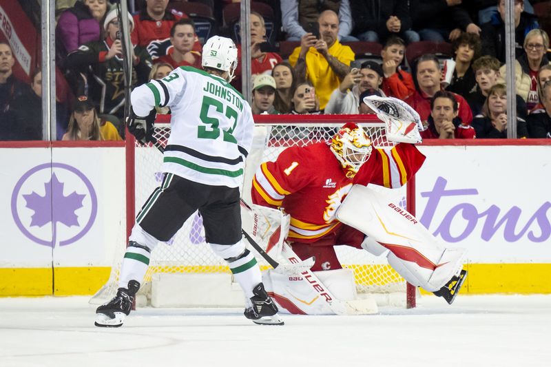 Nov 22, 2025; Calgary, Alberta, CAN; Calgary Flames goaltender Devin Cooley (1) makes a glove save on Dallas Stars center Wyatt Johnston (53) during the shootout at Scotiabank Saddledome. Mandatory Credit: Brett Holmes-Imagn Images