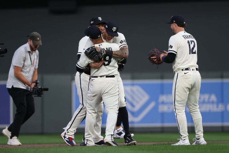 Oct 3, 2023; Minneapolis, Minnesota, USA; Minnesota Twins shortstop Carlos Correa (4) celebrates with first baseman Donovan Solano (39) after defeating Toronto Blue Jays during game one of the Wildcard series for the 2023 MLB playoffs at Target Field. Mandatory Credit: Jesse Johnson-USA TODAY Sports