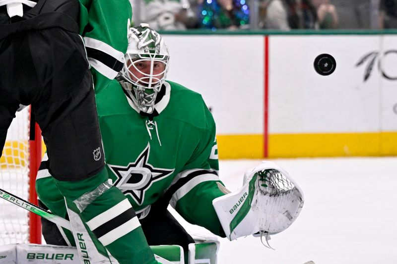 Jan 31, 2025; Dallas, Texas, USA; Dallas Stars goaltender Jake Oettinger (29) makes a save on a Vancouver Canucks shot during the third period at the American Airlines Center. Mandatory Credit: Jerome Miron-Imagn Images