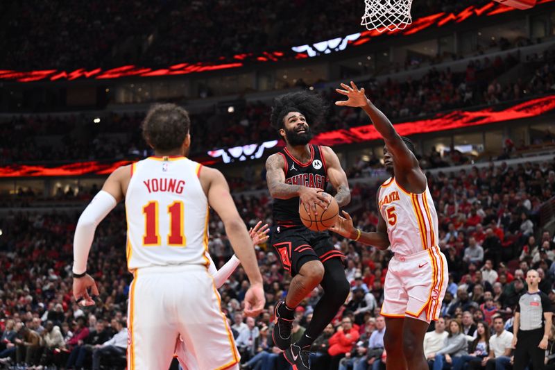 CHICAGO, ILLINOIS - APRIL 17:  Coby White #0 of the Chicago Bulls drives to the basket past Clint Capela #15 of the Atlanta Hawks in the second half on April 17, 2024 at United Center in Chicago, Illinois. Chicago defeated Atlanta 131-116.   NOTE TO USER: User expressly acknowledges and agrees that, by downloading and or using this photograph, User is consenting to the terms and conditions of the Getty Images License Agreement.  (Photo by Jamie Sabau/Getty Images)