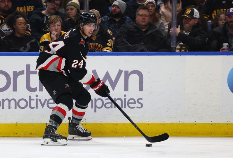 Dec 27, 2023; Buffalo, New York, USA;  Buffalo Sabres center Dylan Cozens (24) looks to make a pass during the second period against the Boston Bruins at KeyBank Center. Mandatory Credit: Timothy T. Ludwig-USA TODAY Sports