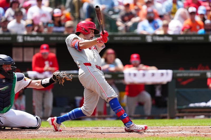 Jun 16, 2024; Baltimore, Maryland, USA; Philadelphia Phillies catcher Garrett Stubbs (21) hits a single against the Baltimore Orioles during the fifth inning at Oriole Park at Camden Yards. Mandatory Credit: Gregory Fisher-USA TODAY Sports