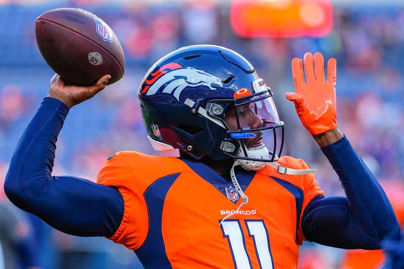 Denver Broncos quarterback Josh Johnson (11) warms up against the Minnesota Vikings during an NFL preseason football game, Saturday, Aug. 27, 2022, in Denver. (AP Photo/Jack Dempsey)