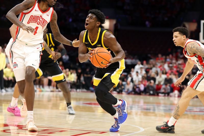 Jan 27, 2025; Columbus, Ohio, USA;  Iowa Hawkeyes guard Drew Thelwell (3) drives to the basket as Ohio State Buckeyes forward Aaron Bradshaw (4) defends during the first half at Value City Arena. Mandatory Credit: Joseph Maiorana-Imagn Images