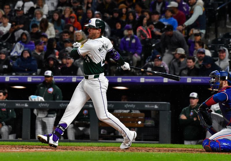 May 11, 2024; Denver, Colorado, USA; Colorado Rockies third base Ryan McMahon (24) singles against the Texas Rangers during the seventh inning at Coors Field. Mandatory Credit: John Leyba-USA TODAY Sports