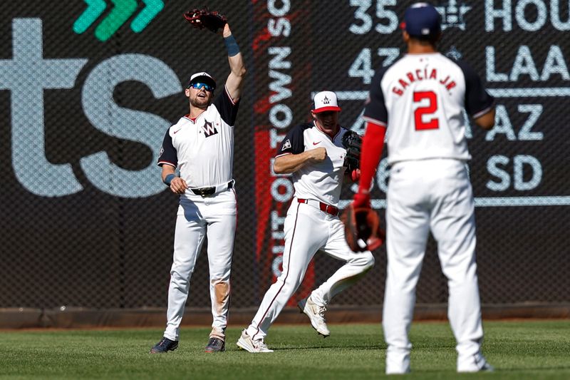 Jun 9, 2024; Washington, District of Columbia, USA; Washington Nationals right fielder Lane Thomas (28) avoids Nationals center fielder Jacob Young (30) while catching a fly ball by Atlanta Braves designated hitter Marcell Ozuna (not pictured) during the ninth inning at Nationals Park. Mandatory Credit: Geoff Burke-USA TODAY Sports