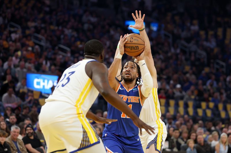 SAN FRANCISCO, CALIFORNIA - MARCH 18: Jalen Brunson #11 of the New York Knicks goes up for a shot on Draymond Green #23 and Brandin Podziemski #2 of the Golden State Warriors at Chase Center on March 18, 2024 in San Francisco, California. NOTE TO USER: User expressly acknowledges and agrees that, by downloading and or using this photograph, User is consenting to the terms and conditions of the Getty Images License Agreement.  (Photo by Ezra Shaw/Getty Images)