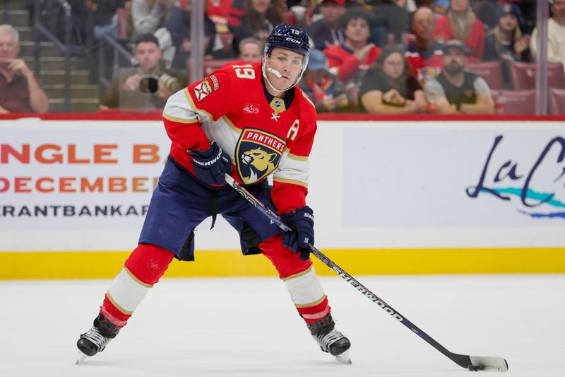 Nov 6, 2023; Sunrise, Florida, USA; Florida Panthers left wing Matthew Tkachuk (19) moves the puck against the Columbus Blue Jackets during the second period at Amerant Bank Arena. Mandatory Credit: Sam Navarro-USA TODAY Sports