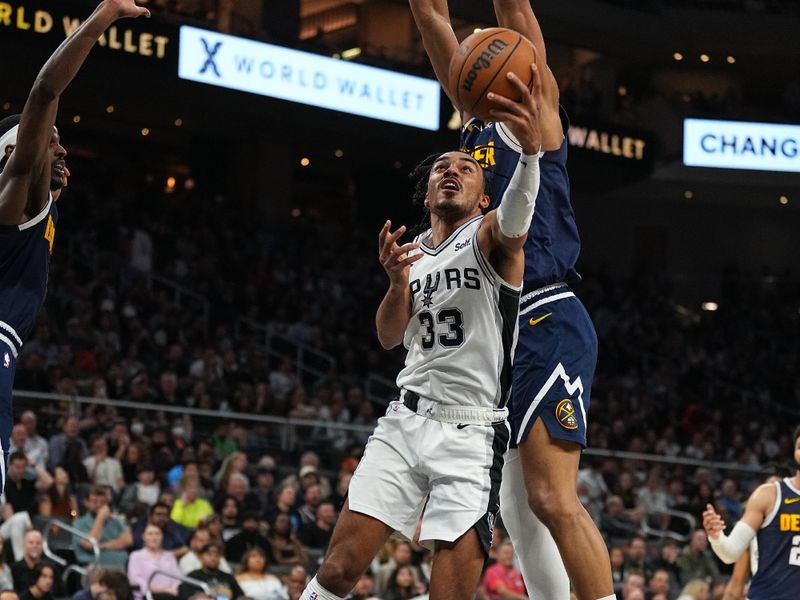 AUSTIN, TX - MARCH 15: Tre Jones #33 of the San Antonio Spurs drives to the basket during the game against the Denver Nuggets on March 15, 2024 at the Moody Center in Austin, Texas. NOTE TO USER: User expressly acknowledges and agrees that, by downloading and/or using this Photograph, user is consenting to the terms and conditions of the Getty Images License Agreement. Mandatory Copyright Notice: Copyright 2024 NBAE (Photo by Garrett Ellwood/NBAE via Getty Images)