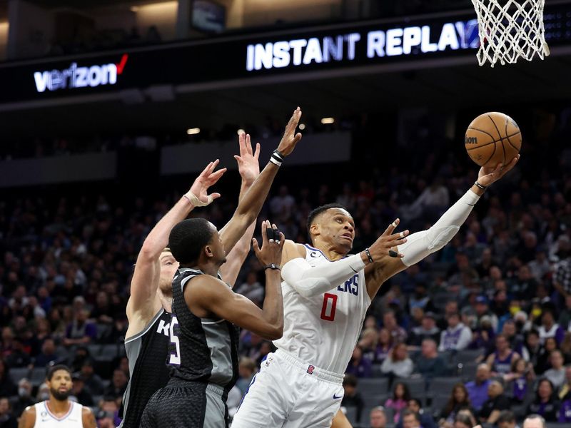 SACRAMENTO, CALIFORNIA - MARCH 03: Russell Westbrook #0 of the LA Clippers goes up for a shot against De'Aaron Fox #5 of the Sacramento Kings at Golden 1 Center on March 03, 2023 in Sacramento, California. NOTE TO USER: User expressly acknowledges and agrees that, by downloading and or using this photograph, User is consenting to the terms and conditions of the Getty Images License Agreement.   (Photo by Ezra Shaw/Getty Images)