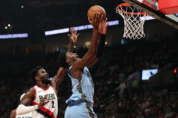 PORTLAND, OREGON - NOVEMBER 05: Jaren Jackson Jr. #13 of the Memphis Grizzlies drives to the basket as Deandre Ayton #2 of the Portland Trail Blazers defends during the first quarter at Moda Center on November 05, 2023 in Portland, Oregon. NOTE TO USER: User expressly acknowledges and agrees that, by downloading and or using this photograph, User is consenting to the terms and conditions of the Getty Images License Agreement.? (Photo by Amanda Loman/Getty Images)