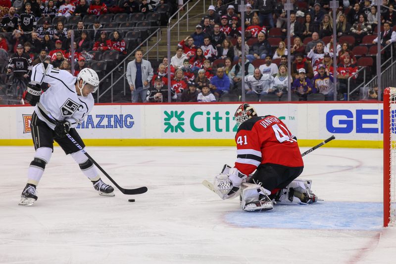 Feb 23, 2023; Newark, New Jersey, USA; Los Angeles Kings center Anze Kopitar (11) skates with the puck towards New Jersey Devils goaltender Vitek Vanecek (41) during the first period at Prudential Center. Mandatory Credit: Ed Mulholland-USA TODAY Sports