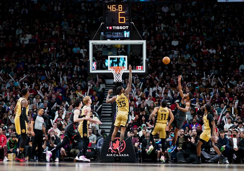 TORONTO, ON - APRIL 7: Jared Butler #4 of the Washington Wizards shoots against Bruce Brown #11 of the Toronto Raptors during the first half of their basketball game at the Scotiabank Arena on April 7, 2024 in Toronto, Ontario, Canada. NOTE TO USER: User expressly acknowledges and agrees that, by downloading and/or using this Photograph, user is consenting to the terms and conditions of the Getty Images License Agreement. (Photo by Mark Blinch/Getty Images)