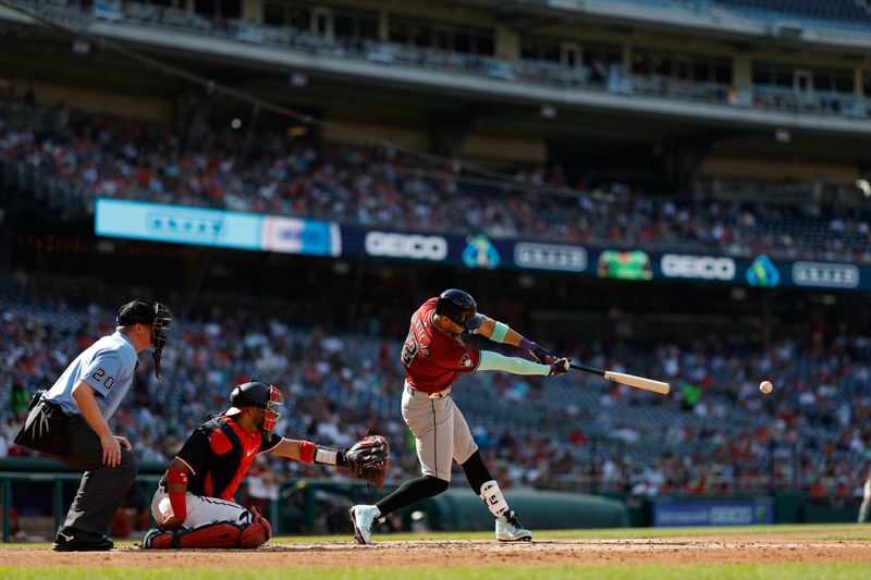 Jun 19, 2024; Washington, District of Columbia, USA; Arizona Diamondbacks outfielder Lourdes Gurriel Jr. (12) singles against the Washington Nationals during the fourth inning at Nationals Park. Mandatory Credit: Geoff Burke-USA TODAY Sports