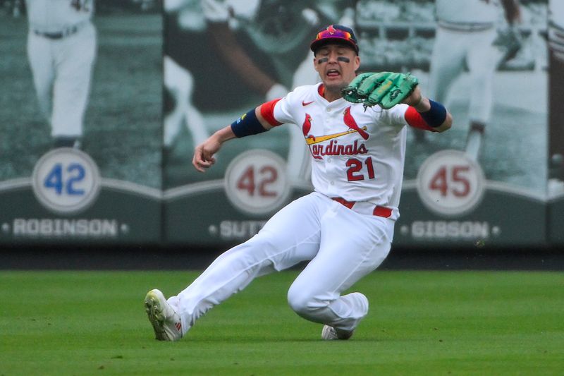 May 25, 2025; St. Louis, Missouri, USA;  St. Louis Cardinals left fielder Lars Nootbaar (21) slides and makes a catch against the Arizona Diamondbacks during the first inning at Busch Stadium. Mandatory Credit: Jeff Curry-Imagn Images