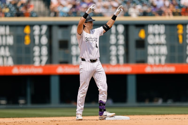 Jul 24, 2024; Denver, Colorado, USA; Colorado Rockies first baseman Michael Toglia (4) reacts from second on a two RBI double in the fourth inning against the Boston Red Sox at Coors Field. Mandatory Credit: Isaiah J. Downing-USA TODAY Sports
