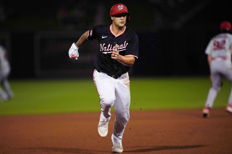 Mar 8, 2024; West Palm Beach, Florida, USA; Washington Nationals third baseman Nick Senzel (13) advances to third base on a base hit in the fourth inning against the St. Louis Cardinals at CACTI Park of the Palm Beaches. Mandatory Credit: Jim Rassol-USA TODAY Sports