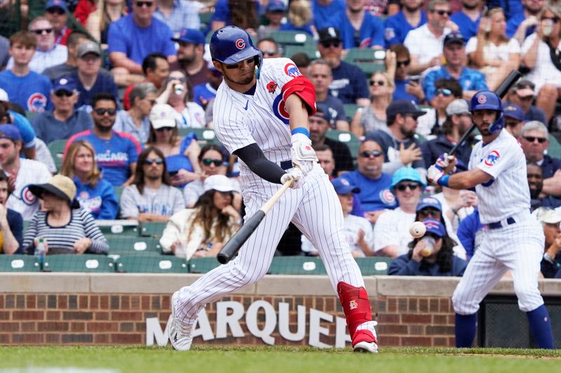 May 29, 2023; Chicago, Illinois, USA; Chicago Cubs right fielder Seiya Suzuki (27) hits a single against the Tampa Bay Rays during the fourth inning at Wrigley Field. Mandatory Credit: David Banks-USA TODAY Sports