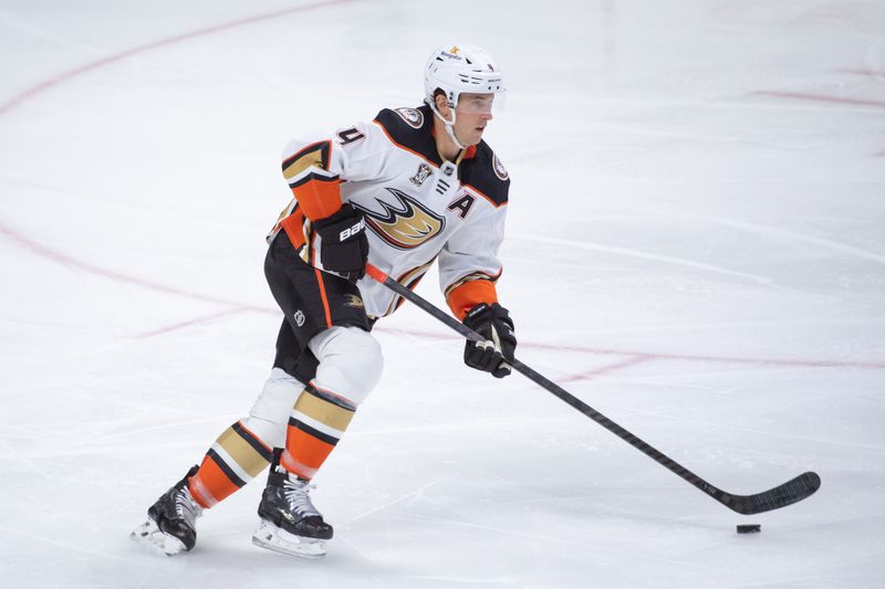 Feb 15, 2024; Ottawa, Ontario, CAN; Anaheim Ducks defenseman Cam Fowler (4) skates with the puck in the third period against the  Ottawa Senators at the Canadian Tire Centre. Mandatory Credit: Marc DesRosiers-USA TODAY Sports