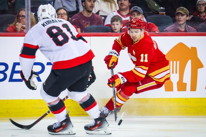 Jan 9, 2024; Calgary, Alberta, CAN; Calgary Flames center Mikael Backlund (11) controls the puck against Ottawa Senators left wing Dominik Kubalik (81) during the second period at Scotiabank Saddledome. Mandatory Credit: Sergei Belski-USA TODAY Sports