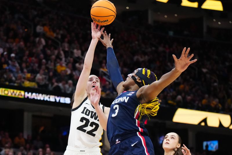 Apr 5, 2024; Cleveland, OH, USA; Iowa Hawkeyes guard Caitlin Clark (22) shoots against Connecticut Huskies forward Aaliyah Edwards (3) in the second quarter in the semifinals of the Final Four of the womens 2024 NCAA Tournament at Rocket Mortgage FieldHouse. Mandatory Credit: Kirby Lee-USA TODAY Sports