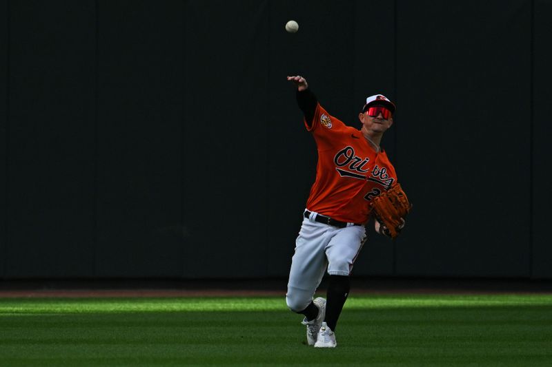 Oct 8, 2023; Baltimore, Maryland, USA; Baltimore Orioles left fielder Austin Hays (21) fields a ball that dropped for a single during the first inning during game two of the ALDS for the 2023 MLB playoffs at Oriole Park at Camden Yards. Mandatory Credit: Tommy Gilligan-USA TODAY Sports