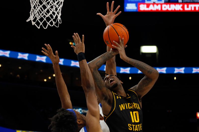 Jan 19, 2023; Memphis, Tennessee, USA; Wichita State Shockers guard Jaykwon Walton (10) shoots as Memphis Tigers forward DeAndre Williams (12) defends during the first half at FedExForum. Mandatory Credit: Petre Thomas-USA TODAY Sports