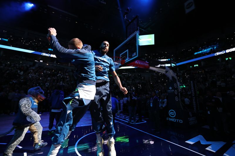 MINNEAPOLIS, MN - NOVEMBER 8: Donte DiVincenzo #0 and Rudy Gobert #27 of the Minnesota Timberwolves celebrate before the game against the Portland Trail Blazers on November 8, 2024 at Target Center in Minneapolis, Minnesota. NOTE TO USER: User expressly acknowledges and agrees that, by downloading and or using this Photograph, user is consenting to the terms and conditions of the Getty Images License Agreement. Mandatory Copyright Notice: Copyright 2024 NBAE (Photo by David Sherman/NBAE via Getty Images)