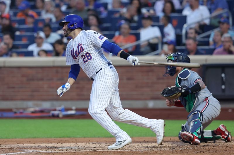 Jul 30, 2024; New York City, New York, USA; New York Mets designated hitter J.D. Martinez (28) follows through on an RBI single against the Minnesota Twins during the fourth inning at Citi Field. Mandatory Credit: Brad Penner-USA TODAY Sports