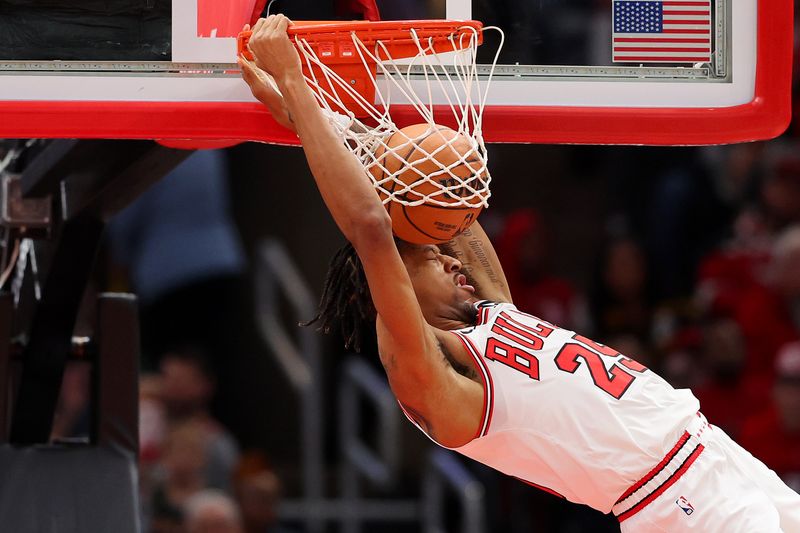 CHICAGO, ILLINOIS - DECEMBER 23: Dalen Terry #25 of the Chicago Bulls dunks against the Cleveland Cavaliers during the first half at the United Center on December 23, 2023 in Chicago, Illinois. NOTE TO USER: User expressly acknowledges and agrees that, by downloading and or using this photograph, User is consenting to the terms and conditions of the Getty Images License Agreement.  (Photo by Michael Reaves/Getty Images)
