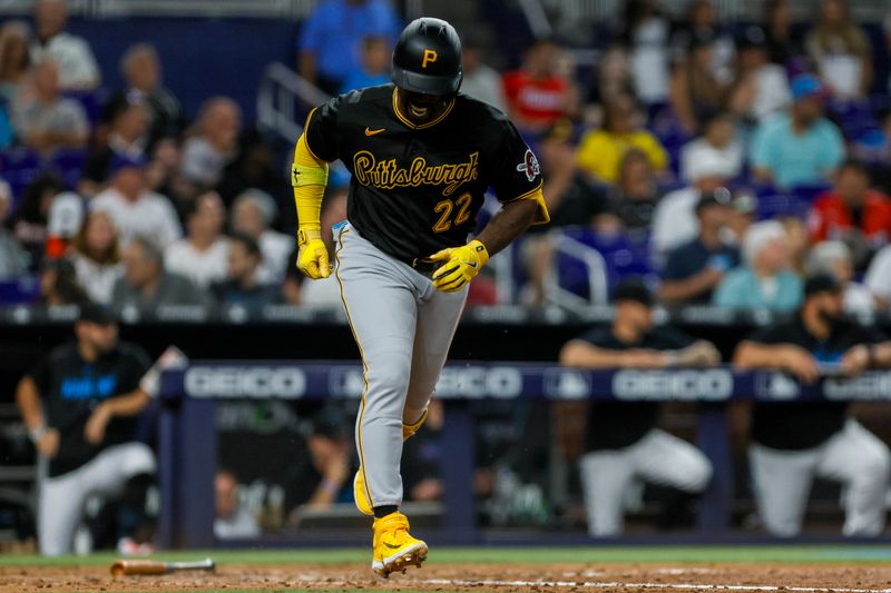 Jun 25, 2023; Miami, Florida, USA; Pittsburgh Pirates designated hitter Andrew McCutchen (22) reacts on his way to first base after hitting a single against the Miami Marlins during the eighth inning at loanDepot Park. Mandatory Credit: Sam Navarro-USA TODAY Sports