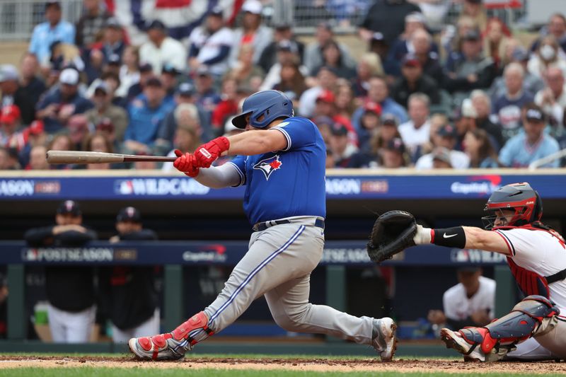 Oct 4, 2023; Minneapolis, Minnesota, USA; Toronto Blue Jays catcher Alejandro Kirk (30) hits a single in the sixth inning against the Minnesota Twins  during game two of the Wildcard series for the 2023 MLB playoffs at Target Field. Mandatory Credit: Jesse Johnson-USA TODAY Sports