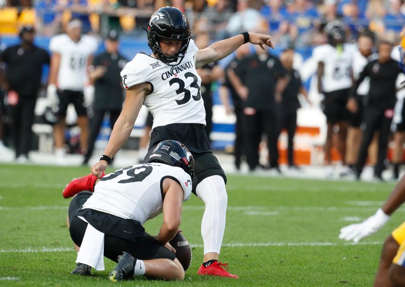 Sep 9, 2023; Pittsburgh, Pennsylvania, USA; Cincinnati Bearcats place kicker Carter Brown (33) kicks a field goal against the Pittsburgh Panthers during the first quarter at Acrisure Stadium. Mandatory Credit: Charles LeClaire-USA TODAY Sports