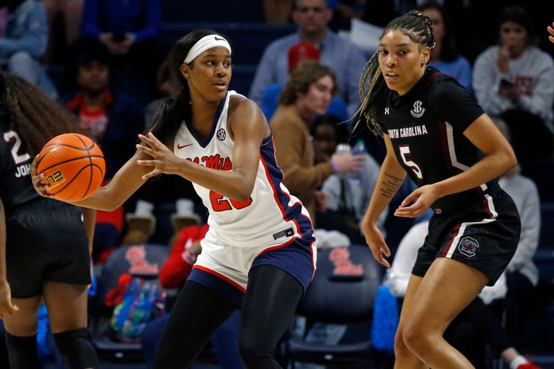 Feb 19, 2023; Oxford, Mississippi, USA; Mississippi Rebels guard Ayanna Thompson (20) handles the ball as South Carolina Gamecocks forward Victaria Saxton (5) defends during the first half at The Sandy and John Black Pavilion at Ole Miss. Mandatory Credit: Petre Thomas-USA TODAY Sports