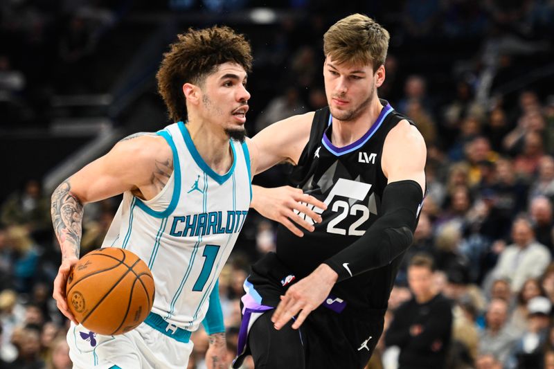 SALT LAKE CITY, UTAH - JANUARY 15: LaMelo Ball #1 of the Charlotte Hornets drives into Kyle Filipowski #22 of the Utah Jazz during the first half of a game at Delta Center on January 15, 2025 in Salt Lake City, Utah. NOTE TO USER: User expressly acknowledges and agrees that, by downloading and or using this photograph, User is consenting to the terms and conditions of the Getty Images License Agreement. (Photo by Alex Goodlett/Getty Images)