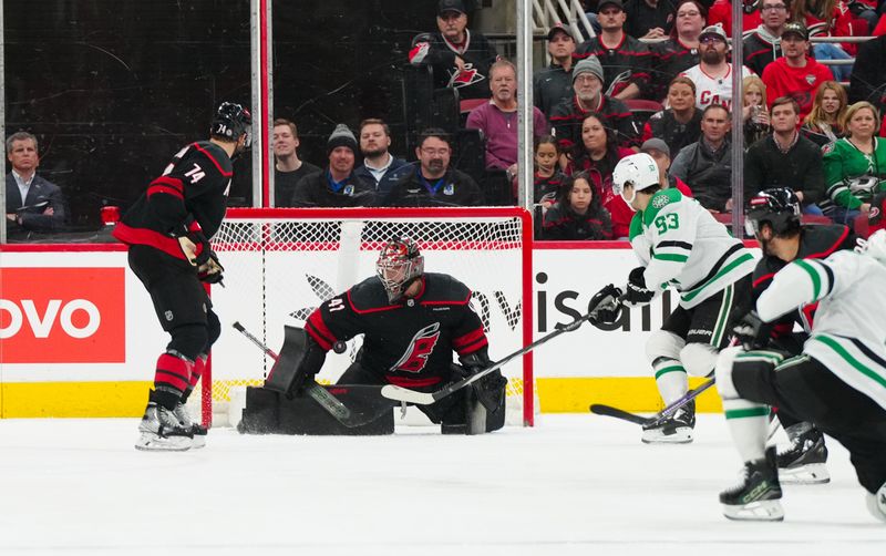 Nov 25, 2024; Raleigh, North Carolina, USA;  Carolina Hurricanes goaltender Spencer Martin (41) stops the scoring attempt by Dallas Stars center Wyatt Johnston (53) during the third period at Lenovo Center. Mandatory Credit: James Guillory-Imagn Images