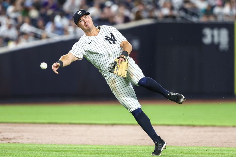 May 22, 2024; Bronx, New York, USA;  New York Yankees shortstop Anthony Volpe (11) throws to to first base for an assist in the sixth inning against the Seattle Mariners at Yankee Stadium. Mandatory Credit: Wendell Cruz-USA TODAY Sports