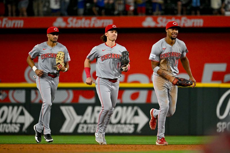 Apr 27, 2024; Arlington, Texas, USA; Cincinnati Reds left fielder Will Benson (30) and right fielder Stuart Fairchild (17) and center fielder Bubba Thompson (12) come off the field after the Red defeat the Texas Rangers at Globe Life Field. Mandatory Credit: Jerome Miron-USA TODAY Sports