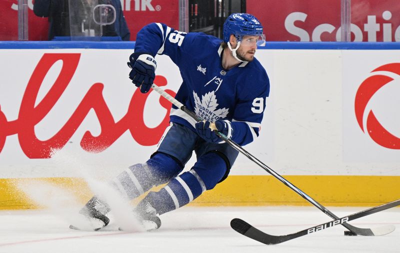 Sep 26, 2024; Toronto, Ontario, CAN;  Toronto Maple Leafs defenseman Oliver Ekman-Larsson (95) turns with the puck against the Montreal Canadiens in the second period at Scotiabank Arena. Mandatory Credit: Dan Hamilton-Imagn Images