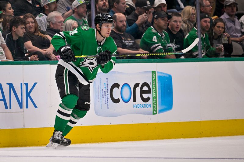 Oct 17, 2022; Dallas, Texas, USA; Dallas Stars center Roope Hintz (24) passes the puck to defenseman Miro Heiskanen (not pictured) who scores a goal against the Winnipeg Jets during the third period at the American Airlines Center. Mandatory Credit: Jerome Miron-USA TODAY Sports