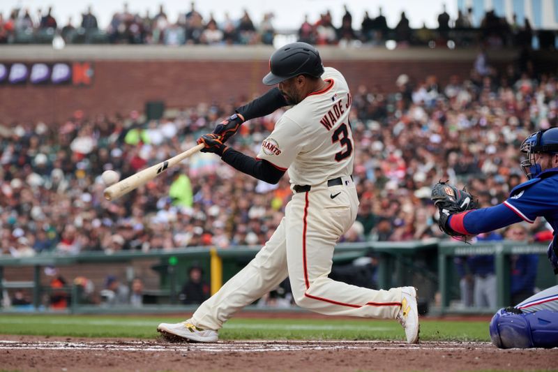 Apr 27, 2025; San Francisco, California, USA; San Francisco Giants first baseman LaMonte Wade Jr. (31) bats against the Texas Rangers during the first inning at Oracle Park. Mandatory Credit: Robert Edwards-Imagn Images