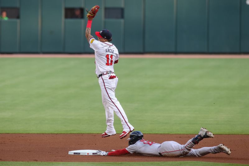 May 8, 2024; Atlanta, Georgia, USA; Boston Red Sox catcher Connor Wong (12) slides in safely with a double past Atlanta Braves shortstop Orlando Arcia (11) in the first inning at Truist Park. Mandatory Credit: Brett Davis-USA TODAY Sports