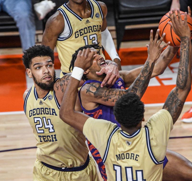 Jan 24, 2023; Clemson, South Carolina, USA; Clemson Tigers guard Dillon Hunter (2) moves to the basket against Georgia Tech Yellow Jackets center Rodney Howard (24) and forward Jalon Moore (14) during the first half at Littlejohn Coliseum. Mandatory Credit: Ken Ruinard-USA TODAY Sports