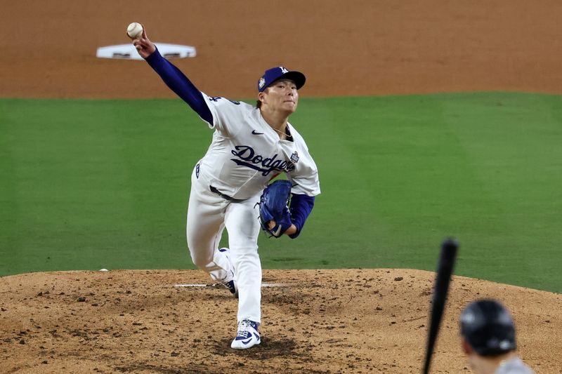 Oct 26, 2024; Los Angeles, California, USA; Los Angeles Dodgers pitcher Yoshinobu Yamamoto (18) throws a pitch against the New York Yankees in the fourth inning for game two of the 2024 MLB World Series at Dodger Stadium. Mandatory Credit: Kiyoshi Mio-Imagn Images