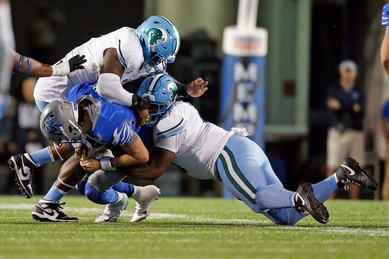 Oct 13, 2023; Memphis, Tennessee, USA; Tulane Green Wave defensive linemen Patrick Jenkins (0) and defensive linemen Darius Hodges (6) sack Memphis Tigers quarterback Seth Henigan (2) during the second half at Simmons Bank Liberty Stadium. Mandatory Credit: Petre Thomas-USA TODAY Sports