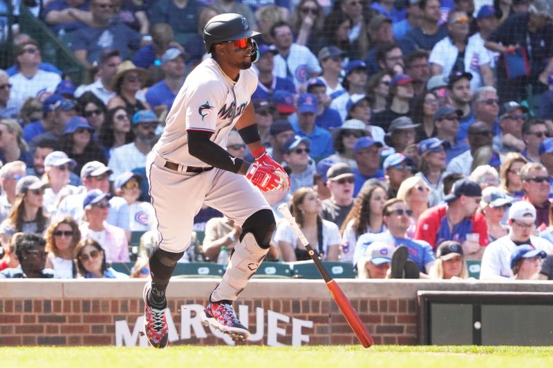 May 7, 2023; Chicago, Illinois, USA; Miami Marlins designated hitter Jorge Soler (12) hits a single against the Chicago Cubs during the eighth inning at Wrigley Field. Mandatory Credit: David Banks-USA TODAY Sports