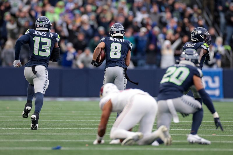 Seattle Seahawks cornerback Coby Bryant (8) runs the ball for a touchdown after making an interception during the second half of an NFL football game against the Arizona Cardinals, Sunday, Nov. 24, 2024, in Seattle. (AP Photo/Jason Redmond)