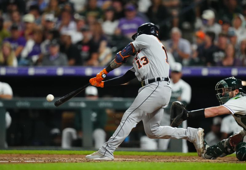 Jul 1, 2023; Denver, Colorado, USA; Detroit Tigers catcher Eric Haase (13) singles in the tenth inning against the Colorado Rockies at Coors Field. Mandatory Credit: Ron Chenoy-USA TODAY Sports