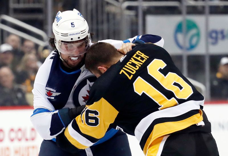 Jan 13, 2023; Pittsburgh, Pennsylvania, USA;  Winnipeg Jets defenseman Brenden Dillon (5) and Pittsburgh Penguins left wing Jason Zucker (16) fight during the third period at PPG Paints Arena. The Jets won 4-1. Mandatory Credit: Charles LeClaire-USA TODAY Sports